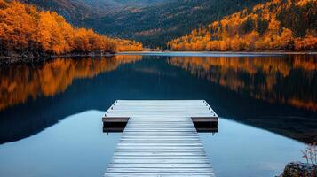 Serene Autumn Lake with Wooden Dock and Vibrant Fall Foliage Reflection photo