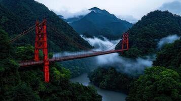 Misty Mountain Landscape with Striking Red Suspension Bridge photo