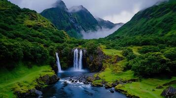 Majestic Waterfall Cascading Down Lush Green Mountains in a Misty Valley photo