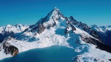 Majestic Snow Capped Mountain Peak with Glacial Lake and Stunning Alpine Scenery photo