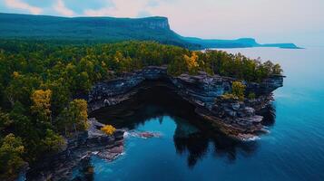 Stunning Aerial View of Dramatic Coastal Cliffs Azure Waters and Autumnal Forest photo