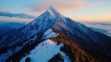 Majestic Snow Capped Mountain Peak at Sunrise Panoramic Aerial View photo