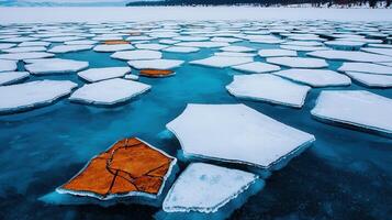 Stunning Aerial View of Fractured Ice Floes on a Turquoise Lake in Winter photo
