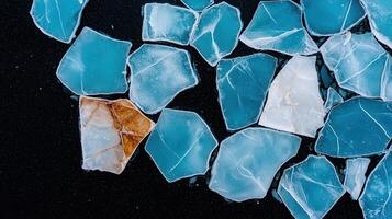 Abstract Ice Fragments Teal White and Brown Texture on Black Background photo