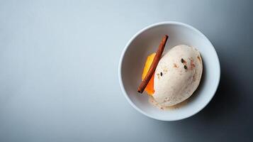 Delicious Creamy Vanilla Ice Cream with Cinnamon Stick and Orange Slice Dessert photo