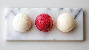 Delicious Trio of Ice Cream Scoops on Marble Slab Vanilla Raspberry and Lemon Sorbet photo