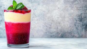 Layered Raspberry Dessert Parfait with Vanilla Cream and Mint Garnish in Glass photo