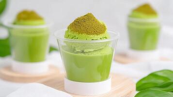 Delicious Matcha Green Tea Ice Cream Dessert in Clear Cups with Powder Topping photo