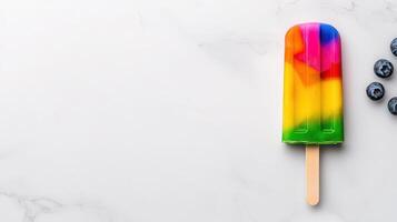 Rainbow Popsicle on Marble Background with Blueberries Summer Dessert Treat photo