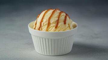 Creamy Vanilla Ice Cream Scoop with Caramel Drizzle in White Bowl photo