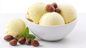 Creamy Vanilla Ice Cream Scoops in Bowl with Hazelnuts and Mint photo