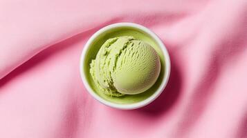 Delicious Green Tea Ice Cream Scoop in White Bowl on Pink Fabric Background photo