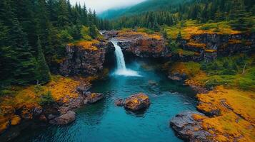 Majestic Waterfall Cascading into Turquoise Pool Surrounded by Lush Evergreen Forest photo
