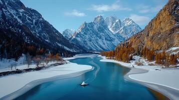 Stunning Aerial View of a Frozen Lake Surrounded by Majestic Snow Capped Mountains and Golden Larch photo
