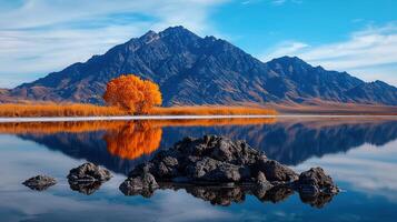 Serene Autumn Landscape Golden Tree Reflecting in Calm Lake with Majestic Mountains photo