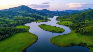 Serpentine River Winding Through Lush Green Valley and Rolling Hills Landscape photo