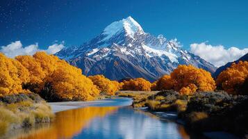 Stunning Autumnal Landscape Golden Trees Snow Capped Mountains Serene River photo