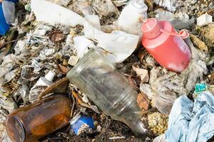 wild garbage dump. residual glass, plastics in the forest photo