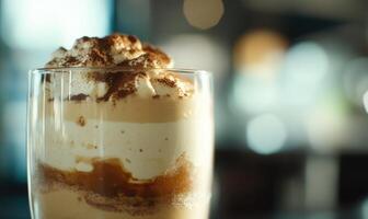 A glass of ice cream with whipped cream on top photo