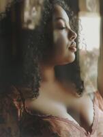 Plus-size woman enjoys a moment of reflection while scrolling through old photos in a warm, cozy room filled with memories