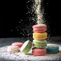 Colorful macarons stacked with powdered sugar falling on a dark background photo