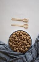 Edible caramel clay stones with a spoon and fork on a white background photo