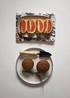 Chocolate cupcakes in a plate with sliced oranges and caramel popcorn on a white background flat lay photo