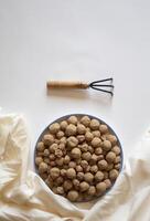 Edible caramel clay stones with a small wrack on a white background minimal flat lay photo