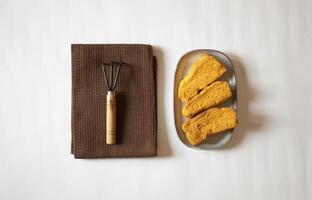 Yellow rusks with a small garden fork minimal flat lay photo