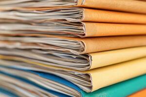 Colorful stacks of organized files resting on a surface in an office setting with natural light illuminating the papers photo