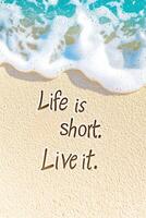 Inspirational quote written in sand on a sunny beach with gentle waves crashing in the background photo