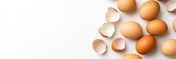 Cracked eggshells arranged in a modern abstract pattern on a white surface creating a minimalist food art concept photo