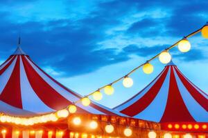 Colorful carnival tent illuminated by glowing string lights creates a festive atmosphere against a twilight sky photo