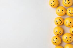 Creative arrangement of playful yellow smiley face balls forming a spherical shape in minimalistic soft lighting at a studio photo