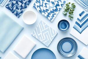 Meticulously arranged mood board showcasing interior design materials in various shades of blue with ceramic tiles, fabric swatches, and decorative accents against a pastel background photo