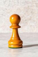 Symbolic chess concept illustrating ambition with a lone pawn casting the shadow of a king under dramatic lighting photo