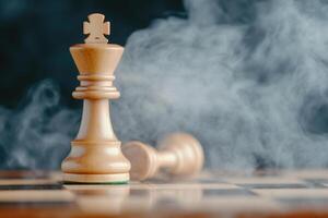 Intense chess battle with a fallen king amidst rising smoke and moody lighting creating a dramatic atmosphere photo
