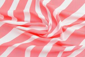 Trendy blush and red striped fabric pattern elegantly draped, showcasing a luxurious texture ideal for fashion and textile branding projects photo