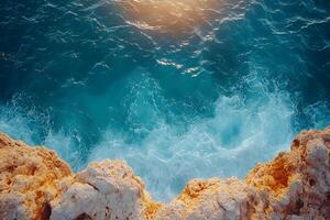 Tranquil Ocean Waves Crashing Against Rocky Shore at Sunset for Nature-Themed Designs photo