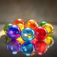 Colorful transparent glass marbles arranged on a reflective surface. Different shades create a vibrant composition with light reflections and refractions. Close-up shot with a blurred background photo