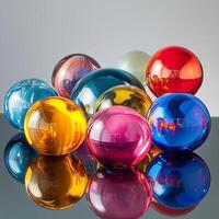 A collection of colorful glass spheres arranged on a reflective surface. The spheres vary in size and color, creating an abstract composition with reflections and highlights photo
