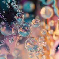 Transparent bubbles of different sizes float in a colorful liquid environment. The background blends warm and cool tones, creating a surreal and dreamy atmosphere photo
