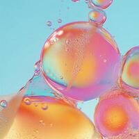 Close-up of oil and water bubbles forming organic shapes with a soft-focus background. Light refractions create a surreal effect, blending orange, pink, and blue hues in a fluid abstract pattern photo