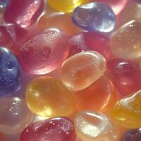 Assorted oval-shaped jelly candies with a smooth, slightly frosted surface. The candies come in soft pastel colors with a gentle shine, creating a delicate and sweet composition photo