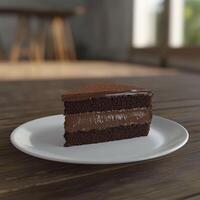 A slice of dark chocolate cake with two layers of glossy chocolate ganache, sitting on a simple white plate on a wooden table. The natural light highlights its rich texture photo