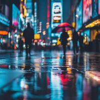 A deserted city road at night glows under neon lights. Rainwater pools on the asphalt, creating a mirror-like surface that reflects the surrounding buildings and streetlights photo