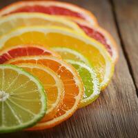 Freshly sliced lemon, lime, orange, and grapefruit arranged on a rustic wooden surface. The juicy texture and vibrant colors highlight the refreshing and natural appeal of citrus fruits photo