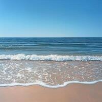 Serene ocean view with foamy waves softly washing over the golden sand. The endless horizon meets the clear sky, evoking a sense of calm and relaxation in a sunlit coastal setting photo