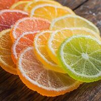A close-up of citrus fruit slices, including lemon, lime, orange, and grapefruit. The juicy, translucent pulp glistens under the light, showcasing their fresh and tangy nature photo