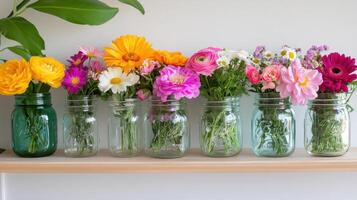 Vibrant wildflowers in mason jars brighten a shelf in a cozy home setting photo